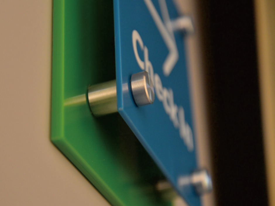 floating sign mounted with aluminium standoffs in lobby